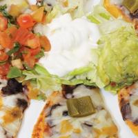Mini Nacho Platter · Corn tortillas smothered with refried beans, melted monterey jack cheese, topped with sour c...