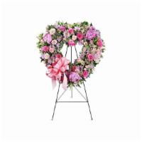 With Open Hearts™ · This sweet standing open heart spray honors the dearly departed with a blush of pink roses a...