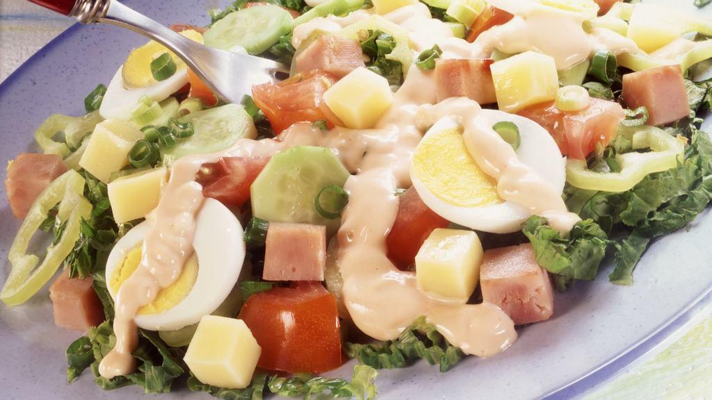 Chef Salad · Romaine, turkey, tomato, chickpeas, cheddar cheese, hard boiled egg, cucumber, and croutons.