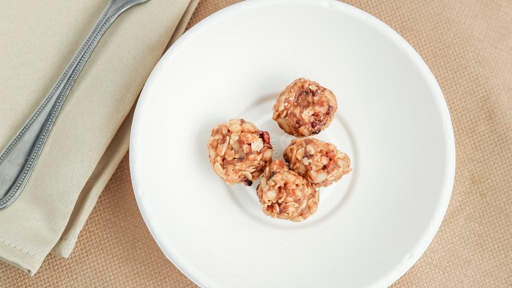Energy Balls · Balls of Almond butter, gluten-free oats, cacao, Macadamia nuts , Flax seeds and Maple.