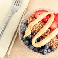 Peanut Butter & Jelly Bowl · Pick a Bowl Base.
Topped with strawberries, blueberries, peanut butter, peanut butter granol...