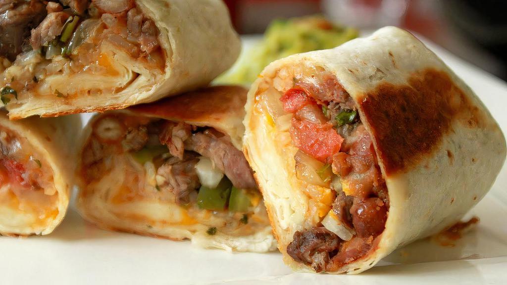 Grilled Steak Burrito · Filled with rice, beans, mild salsa, sour cream, mix cheddar, and jack cheese and pico de gallo.