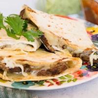 Grilled Steak Quesadilla · Filled with pico de gallo, mixed cheddar and jack cheese, salsa and sour cream on the side.