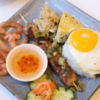 Grilled Pork Rice Combo · Traditional home meal composed of rice, grilled pork, shredded pork skin, steamed meatloaf, ...