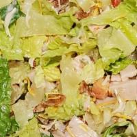 Turkey Club Chopped Salad · chopped romaine with diced tomatoes, bacon, red onion, fresh roasted turkey and cheddar chee...