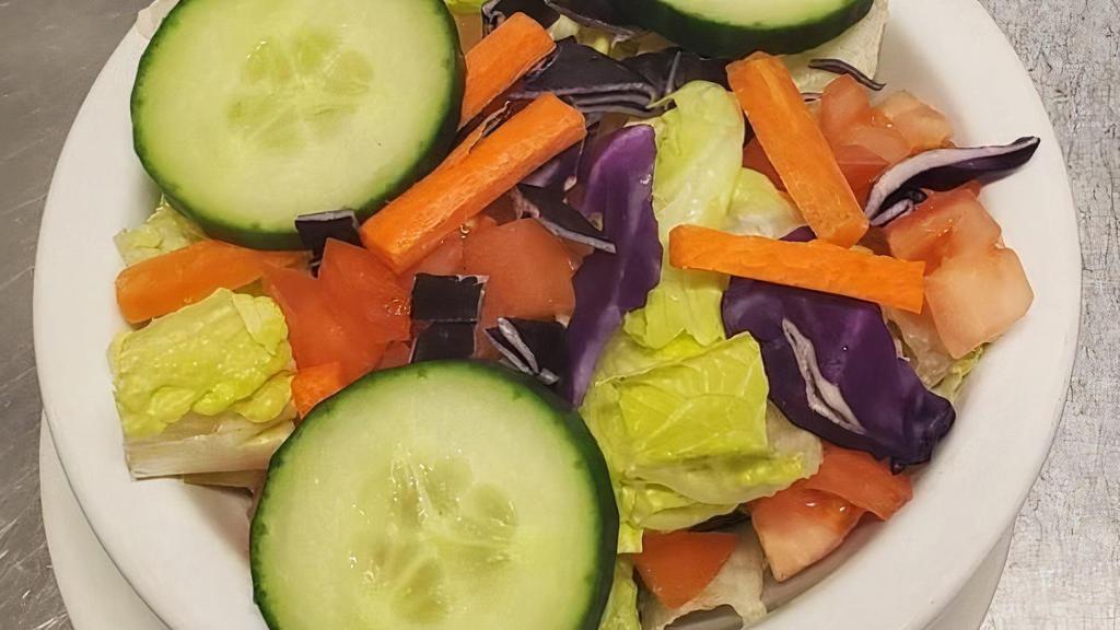 Side Salad · small side salad with tomatoes, carrots, cucumbers and purple cabbage served with your choice of dressing