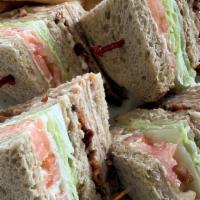 Turkey Club · oven-roasted turkey breast piled high with crisp bacon, lettuce, tomato and mayo on triple d...