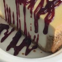 New York Style Cheesecake · new york style creamy cheesecake with raspberry drizzle