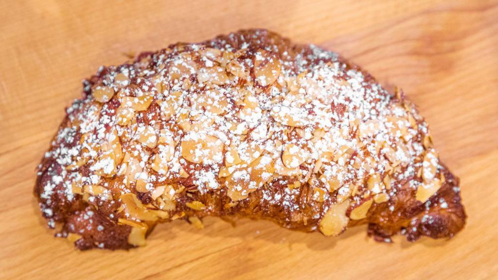 Almond Croissant · Almond-cream-filled croissant topped with toasted almond slices and powdered sugar

*contains nuts