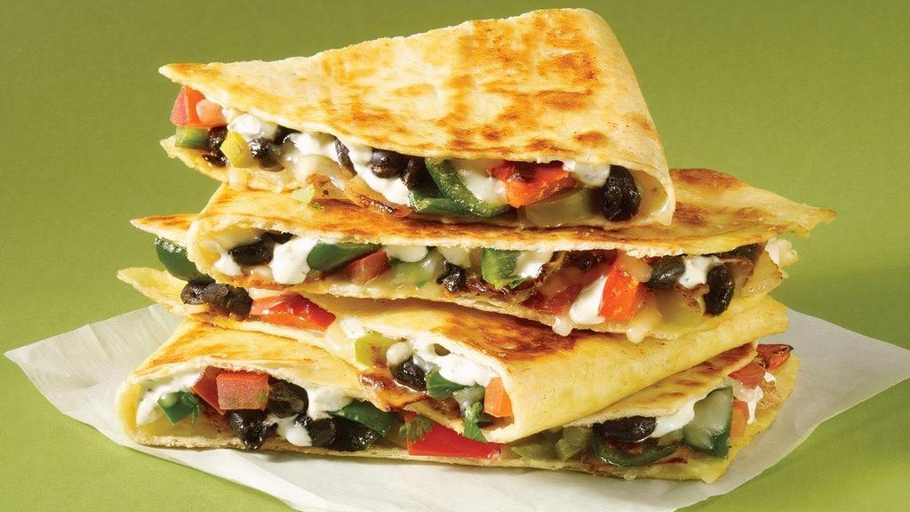 The Savage Garden Quesadilla (V) · Love it as is: This veggie ‘rito is crafted with black beans, sautéed peppers & onions,  jalapeño ranch, pico de gallo, pickled jalapeños, cotija cheese & a jalapeño tortilla. Stand with it on a mountain, bathe with it in the sea, or whatever.. A bit too spicy for you? Choose Tame it Down and we’ll leave off the pickled jalapenos, drizzle with our buttermilk ranch instead jalapeno ranch and use our traditional flour tortilla