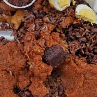 Waakye · Rice and beans. With fish, goat, boiled egg and black sauce.