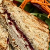 Turkey And Brie Sandy · Roast turkey, warm brie, cranberry compote, champagne mustard, toasted whole wheat.