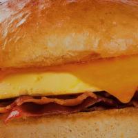 Bacon Cheddar Sandwich  · Cheddar cheese, bacon and eggs on a toasted buttered bun. Served with home fries and fresh f...