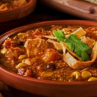 Tortilla · Mexican-inspired soup with tomato broth,   corn tortillas, cheese and avocado.