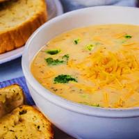 Broccoli Cheddar  · Onion and garlic-base soup, simmered with veggie stack, broccoli, carrots and cheddar.