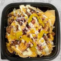 Pulled Beef  Nachos · Pulled beef on crispy nachos topped with pickled jalapenos, red onions, garlic aioli & BBQ s...
