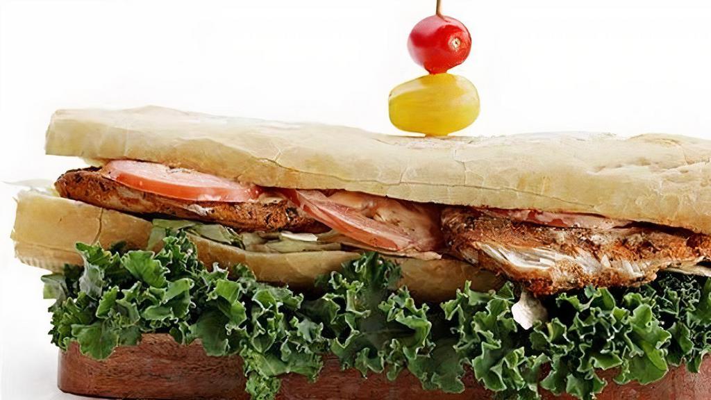 Shnitzel Sandwich · Fried Chicken Breast;. Topped with Lettuce, Tomato, and Garlic Mayo.. Served on a Baguette.