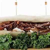 Pulled Beef Sandwhich · pulled beef with carnalized onion . BBQ sauce . Cole slaw . served on a baguette(hamotzi). t...