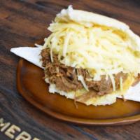 Pelua Arepa · Grilled corn dough patty (arepa) filled with shredded beef and, grated yellow cheese.