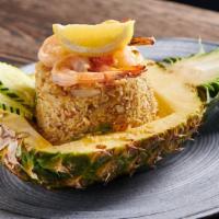 Pineapple Fried Rice · Stir-fried jasmine rice with shrimp, pineapples, onions, scallions, tomatoes, carrots, and e...