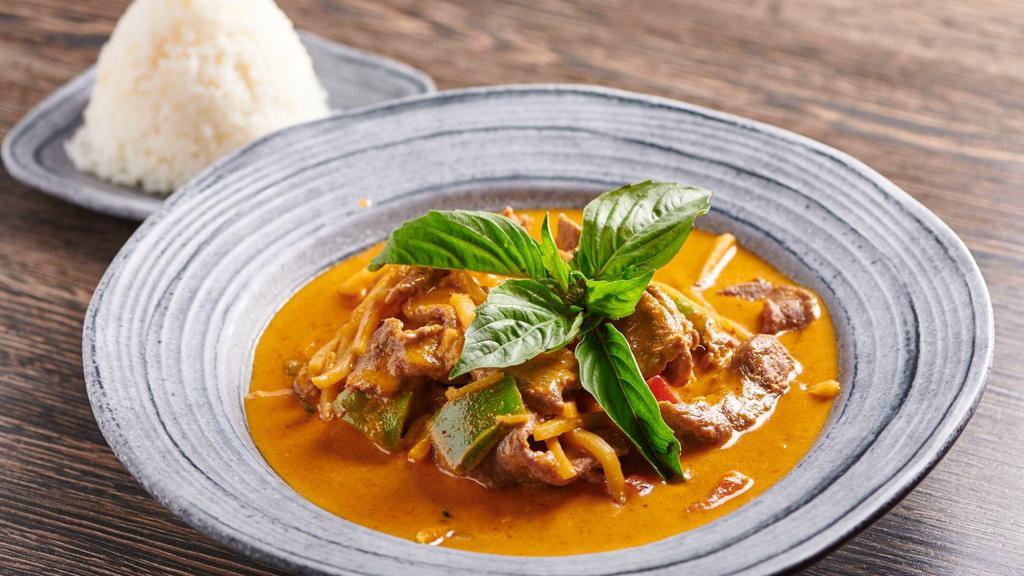Red Curry · Stop! Get this! Bell peppers, bamboo shoots and basil leaves simmered in coconut milk with red chili paste, blended with Thai herbs and spices.