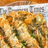Korean Pancake  해물파전 · With seafood and scallions.
