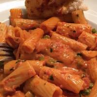 Rigatoni Alla Vodka · Fresh basil panchetta and green peas sauteed with scallions and vodka in a pink sauce with i...