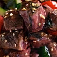 Soy Sesame Steak Poke Bowl · Top Sirloin Steak tossed in a Soy Sesame Sauce mixed with limu, toasted sesame seeds, and re...