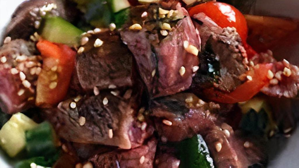 Soy Sesame Steak Poke Bowl · Top Sirloin Steak tossed in a Soy Sesame Sauce mixed with limu, toasted sesame seeds, and red onions