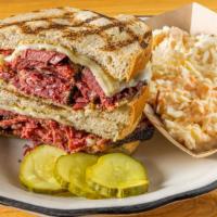Pastrami Sandwich · House smoked pastrami with Swiss & mustard on rye, served with a small of slaw and fries or ...