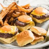 Sliders · Three mini cheeseburgers topped with homemade kettle burger sauce served with pickle and han...