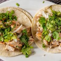 Tacos · Beef or chicken on a soft corn tortilla with onion and cilantro.
