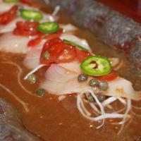 Yellowtail Jalapeno · Spicy. six pieces of Yellowtail & jalapeno with tomato caper sauce.