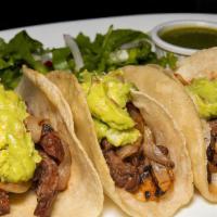 Carne Asada  Tacos · Three soft corn tortillas, sauteed onions, skirt steak, and guacamole.