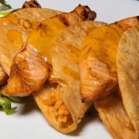 Salmon Tacos · Three hard taco shells, rice, grilled salmon, topped with a chipotle crema.
