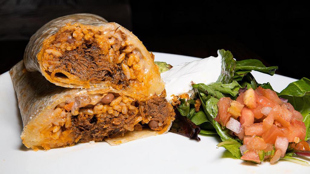 Beef Burrito · Hand-prepared flour tortilla with beef, cheese, red rice, pinto beans, sour cream and guacamole.