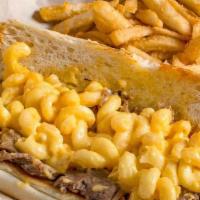 Mac N Cheesesteak · Shaved ribeye piled high with our home made Mac N Cheese. Served on a club roll with fries