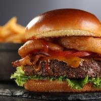 Bbq Burger · Melted cheddar cheese, bacon, onion rings, lettuce, tomato and bbq sauce. Served with fries
