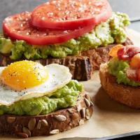 Avocado Toast · Toasted Multigrain bread with smashed avocado topped with tomato and served with bacon or sa...