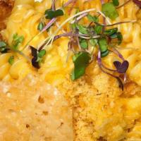 Mac N Chicken Schnitzel · breaded chicken filet topped with mac & cheese, parmesan crisp.