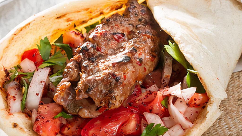 Lamb Adana · Hand chopped grounded lamb served with red peppers on skewers.