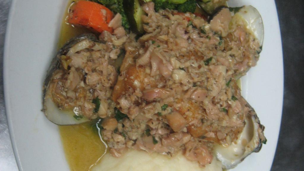 Seafood Paella · Served with shrimp, mussels, calamari and chorizo.