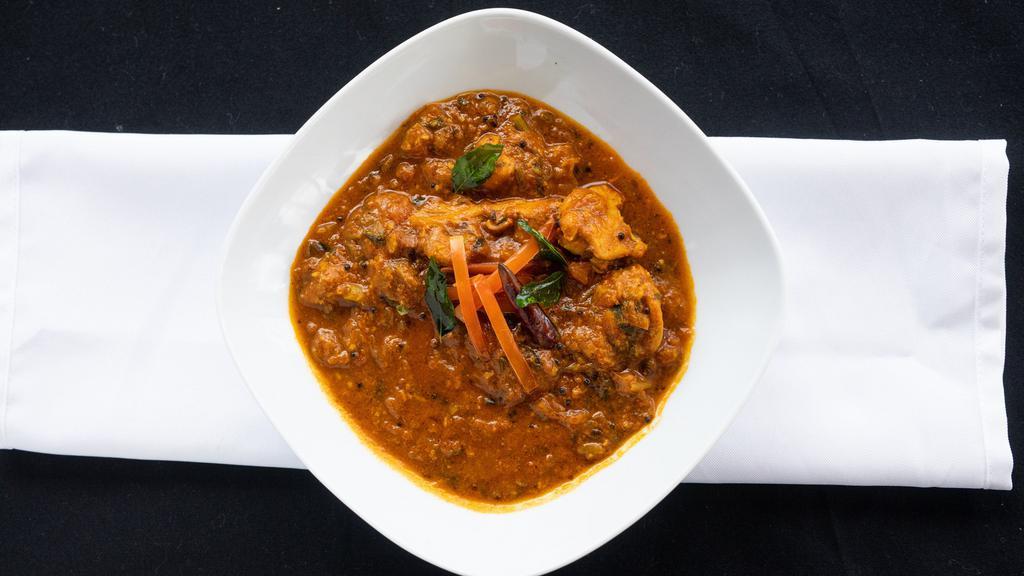 Chicken Madras · Chicken tempered with curry leaves, mustard, whole red chilies and cooked in a special coconut sauce.