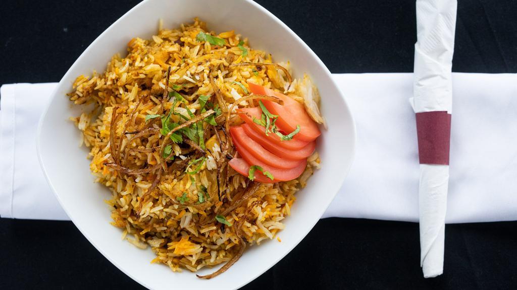Chicken Biryani · Pieces of chicken cooked with rice and flavored with spices.