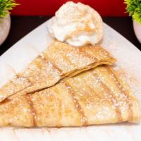 Cinnamon Roll Crepe · Homemade sweet cream melted in a cinnamon swirled crepe topped with icing.