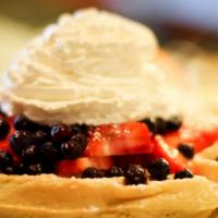 Berries & Cream Waffle · Fresh strawberries, blueberries, raspberry sauce, whipped cream.