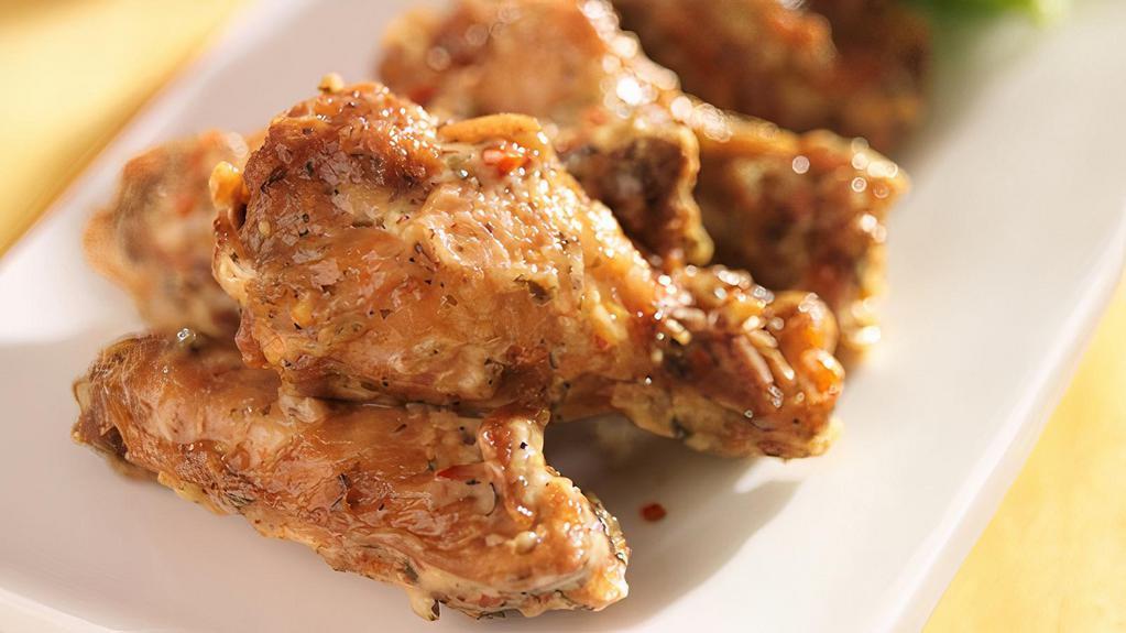 The Garlic Parmesan Wings · Chicken wings fried to golden perfection, topped with Garlic Parmesan sauce.