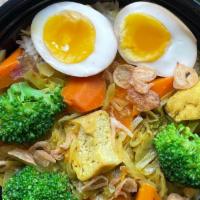 Turmeric-Coconut Stewed Vegetables Over Rice (Sayur Lodeh) · A hearty stew of cabbage, carrots, broccoli, tofu puffs and onions, served over a bed of gar...