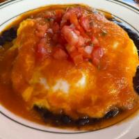 Huevos Rancheros · Homemade crispy tostada with fried eggs, cheddar cheese, black beans, pico de gallo, and ran...