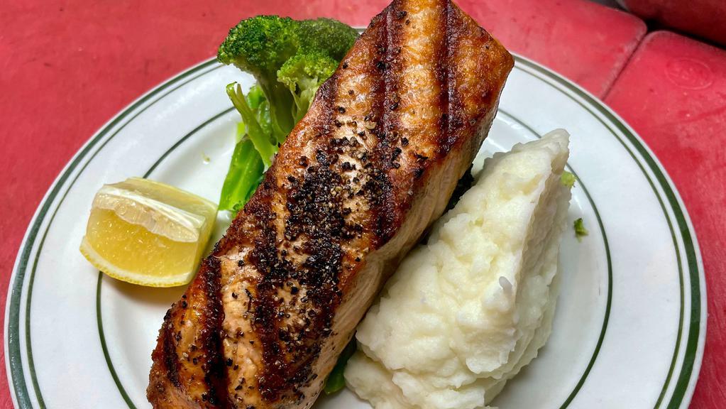 Grilled Salmon · Grilled salmon with french fries, sautéed broccoli, and lemon butter sauce.